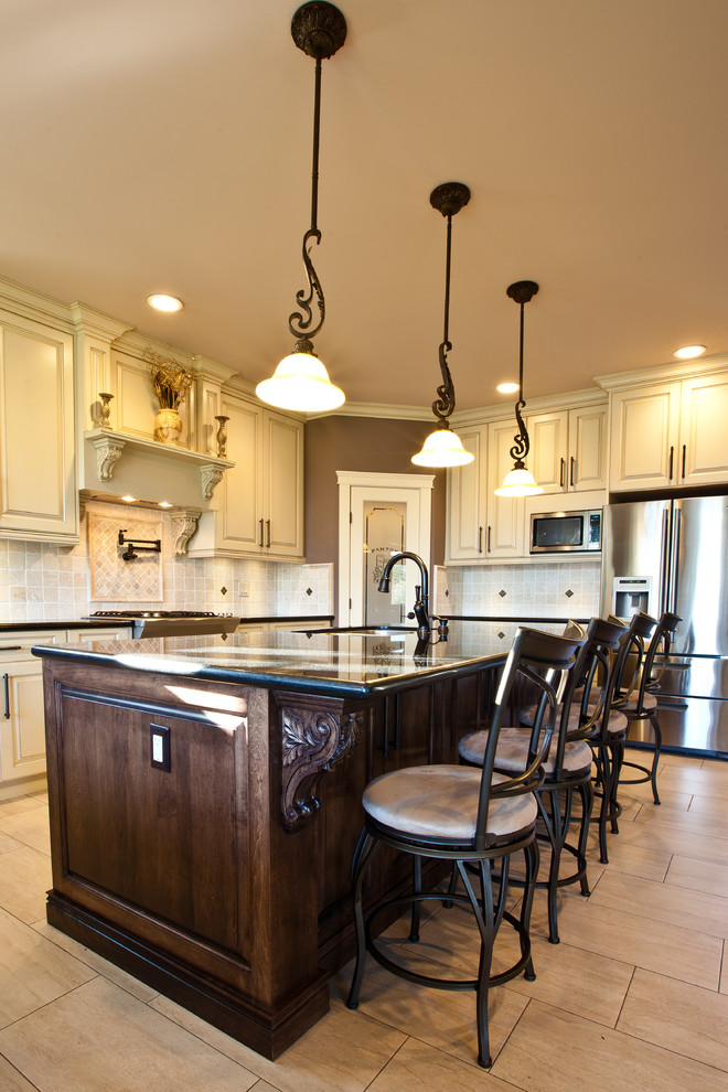 Elegant l-shaped eat-in kitchen photo in Vancouver with raised-panel cabinets, white cabinets, granite countertops, multicolored backsplash, mosaic tile backsplash, stainless steel appliances and an undermount sink