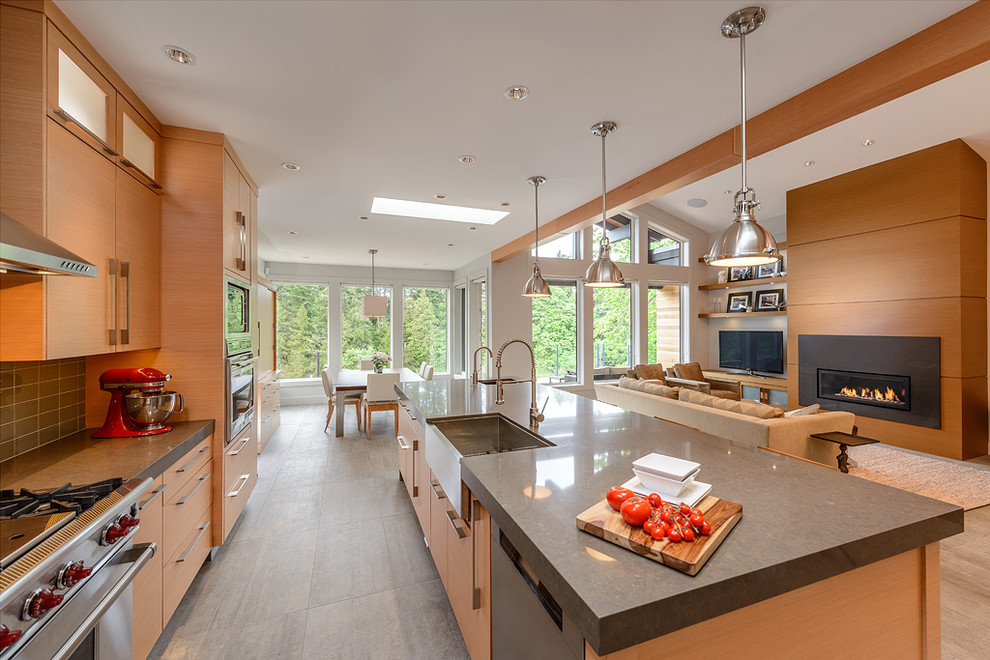 Contemporary kitchen in Vancouver with flat-panel cabinets, a belfast sink and stainless steel appliances.