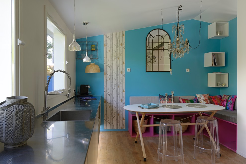Foto di un cucina con isola centrale minimal con lavello da incasso, paraspruzzi bianco e parquet chiaro