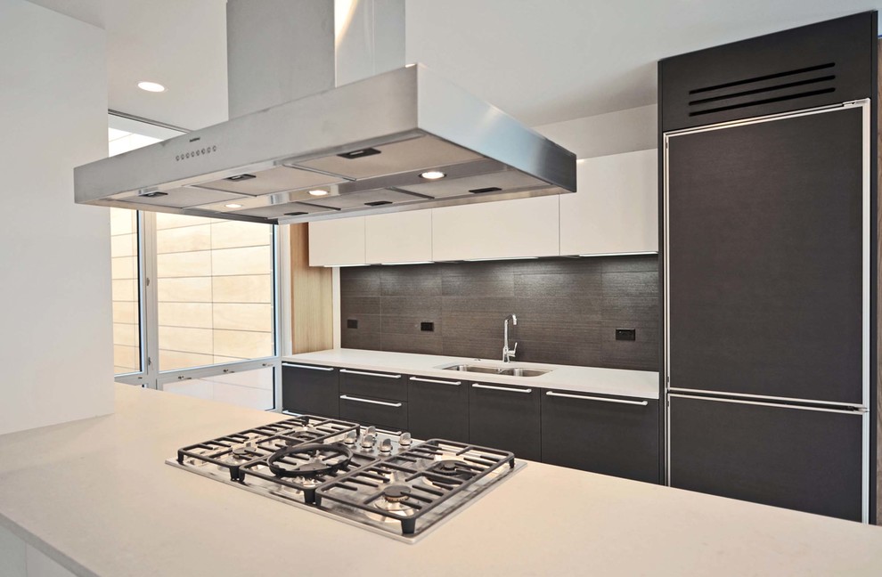 Inspiration for a mid-sized contemporary l-shaped limestone floor eat-in kitchen remodel in Chicago with a double-bowl sink, flat-panel cabinets, dark wood cabinets, black backsplash, porcelain backsplash, white appliances and an island