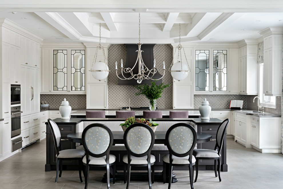 This is an example of a large classic u-shaped enclosed kitchen in Toronto with a submerged sink, shaker cabinets, white cabinets, engineered stone countertops, stainless steel appliances, ceramic flooring, multiple islands, grey floors, grey worktops, mosaic tiled splashback and brown splashback.