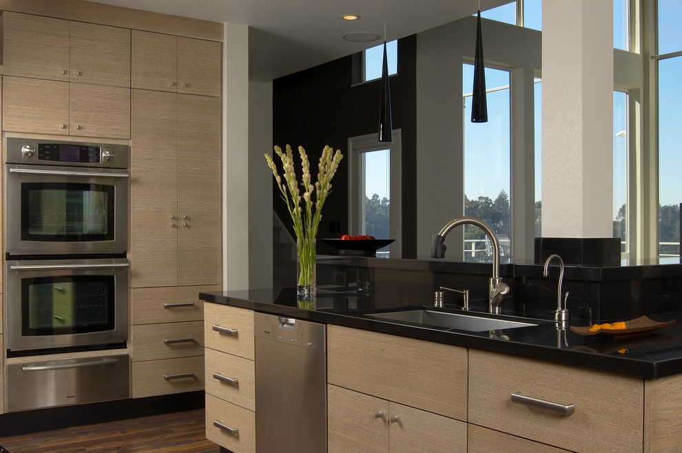 Kitchen - contemporary kitchen idea in San Francisco with flat-panel cabinets, an undermount sink, light wood cabinets, granite countertops and stainless steel appliances