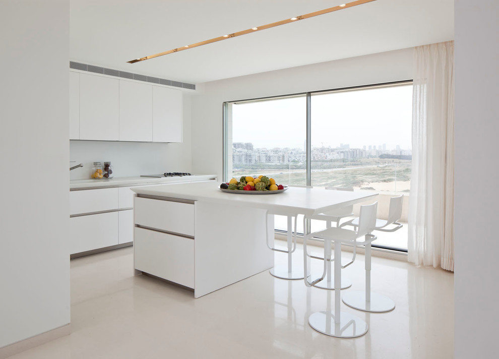 Minimalist kitchen photo in Tel Aviv with flat-panel cabinets, white cabinets and white backsplash