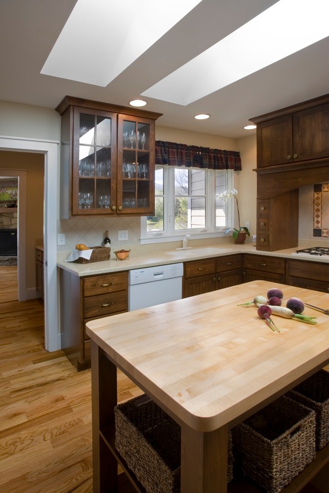 Design ideas for a traditional kitchen in Other with glass-front cabinets, dark wood cabinets and white appliances.