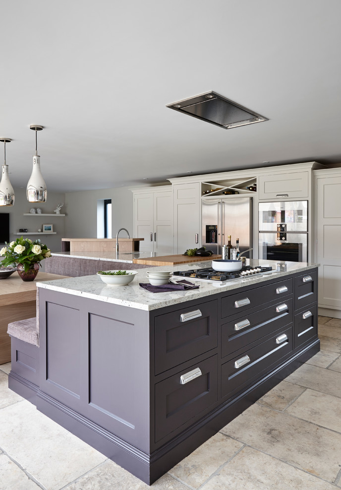 This is an example of a large contemporary l-shaped kitchen/diner in London with flat-panel cabinets, granite worktops, stainless steel appliances and an island.