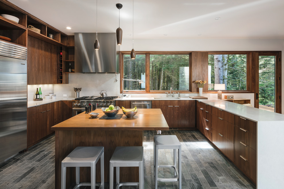 Example of a trendy u-shaped multicolored floor eat-in kitchen design in Portland with an undermount sink, flat-panel cabinets, medium tone wood cabinets, white backsplash, stainless steel appliances, an island and white countertops