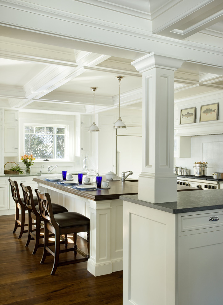 Example of a classic kitchen design in Boston with recessed-panel cabinets, white cabinets and white backsplash