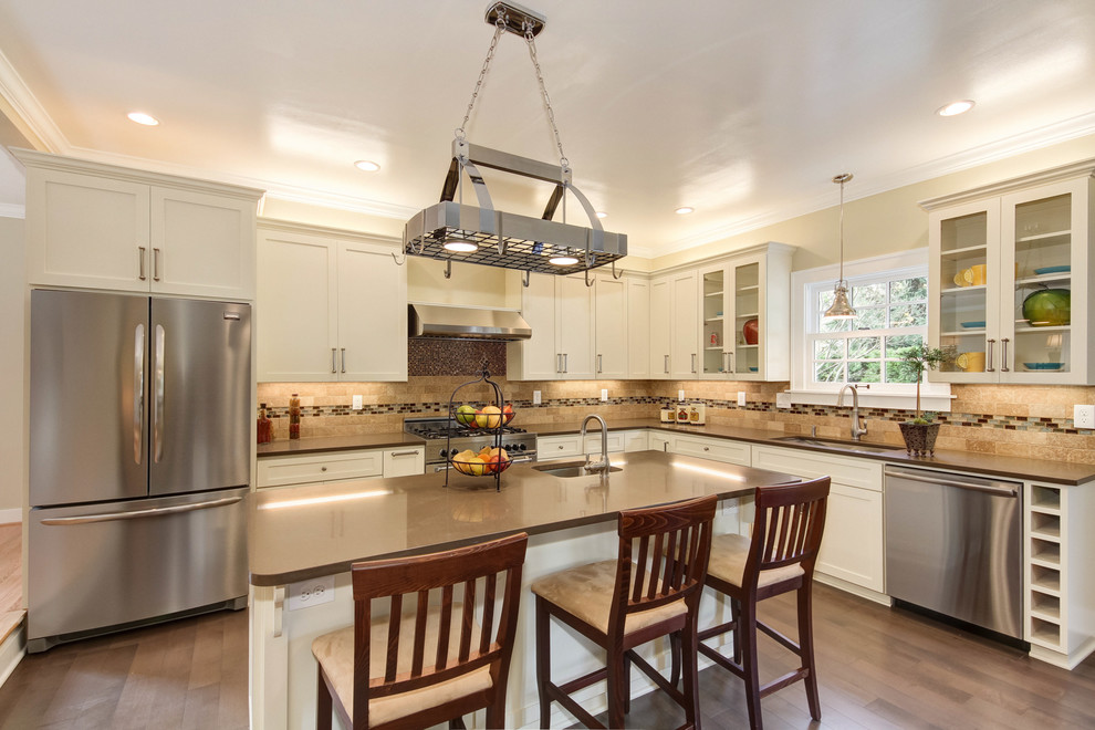 Kitchen - traditional l-shaped kitchen idea in Portland with an undermount sink, shaker cabinets, white cabinets, beige backsplash and stainless steel appliances