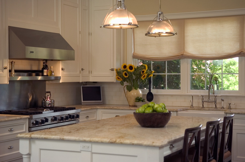 Inspiration for a timeless kitchen remodel in New York with recessed-panel cabinets, a farmhouse sink, white cabinets, white backsplash, subway tile backsplash and stainless steel appliances