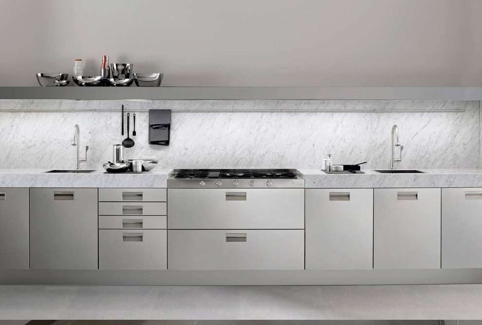 Esempio di una cucina design con ante lisce, ante in acciaio inossidabile, top in marmo, elettrodomestici in acciaio inossidabile e pavimento in cemento