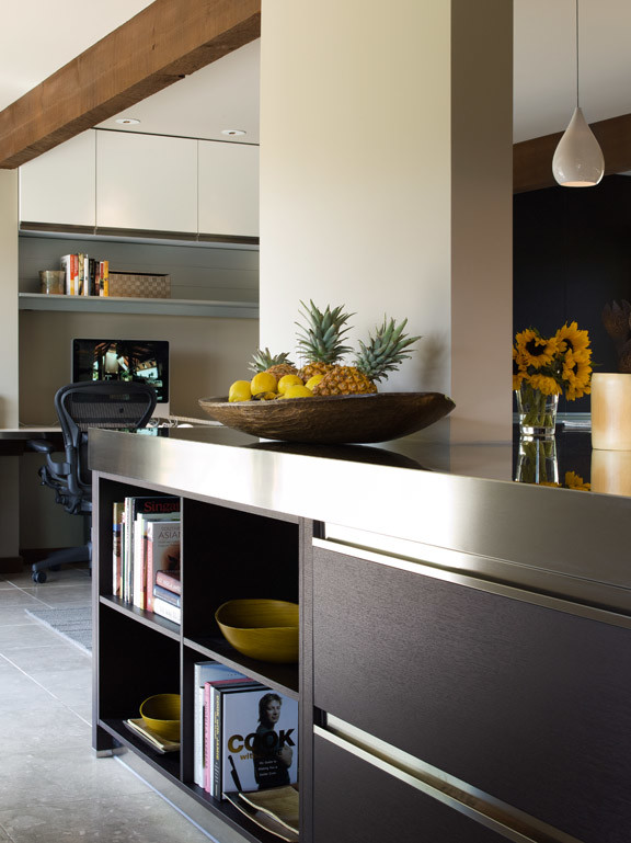 Eat-in kitchen - large modern u-shaped eat-in kitchen idea in San Francisco with an integrated sink, flat-panel cabinets, dark wood cabinets, stainless steel countertops, paneled appliances and a peninsula
