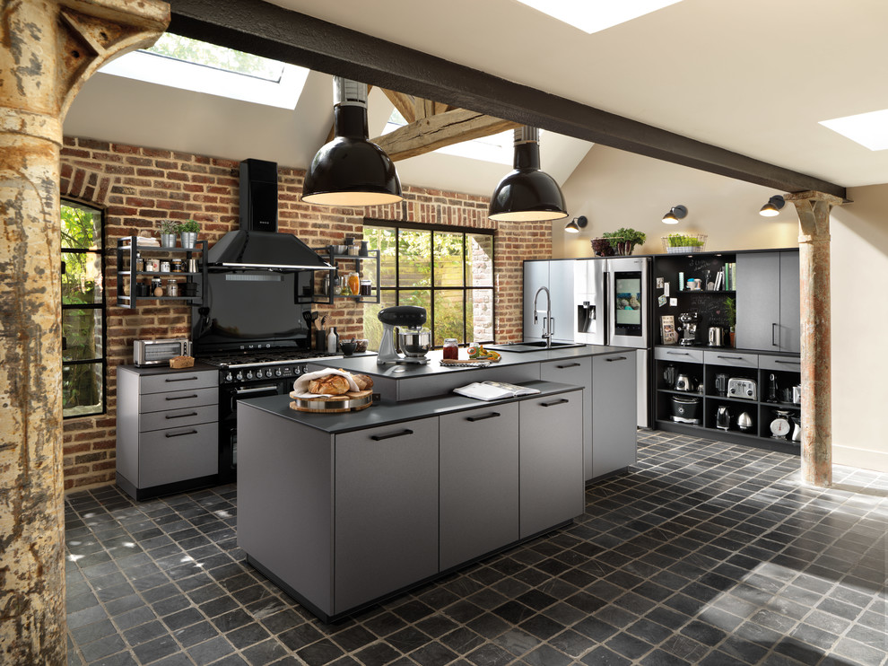 Inspiration for a large urban single-wall open plan kitchen in Surrey with a single-bowl sink, flat-panel cabinets, laminate countertops, black appliances, slate flooring, an island, black floors and black worktops.