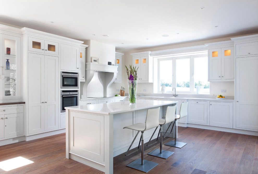 Inspiration for a large contemporary l-shaped medium tone wood floor eat-in kitchen remodel in Dublin with an undermount sink, beaded inset cabinets, white cabinets, quartz countertops, stainless steel appliances and an island