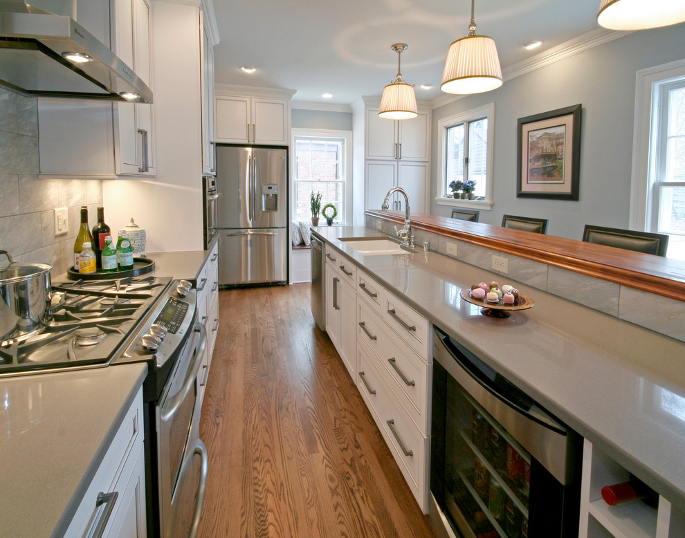 Kitchen - traditional kitchen idea in Milwaukee with stainless steel appliances, quartz countertops, a double-bowl sink and gray countertops