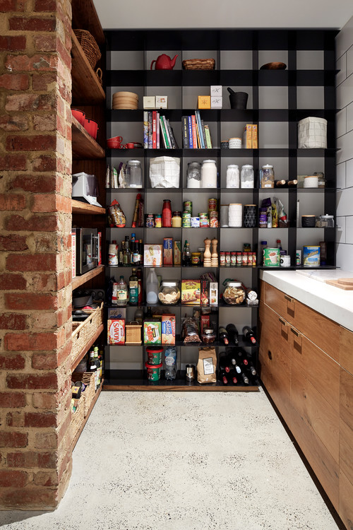 Chic Pantry Storage: Black Shelving and Brick Niches for an Open Kitchen