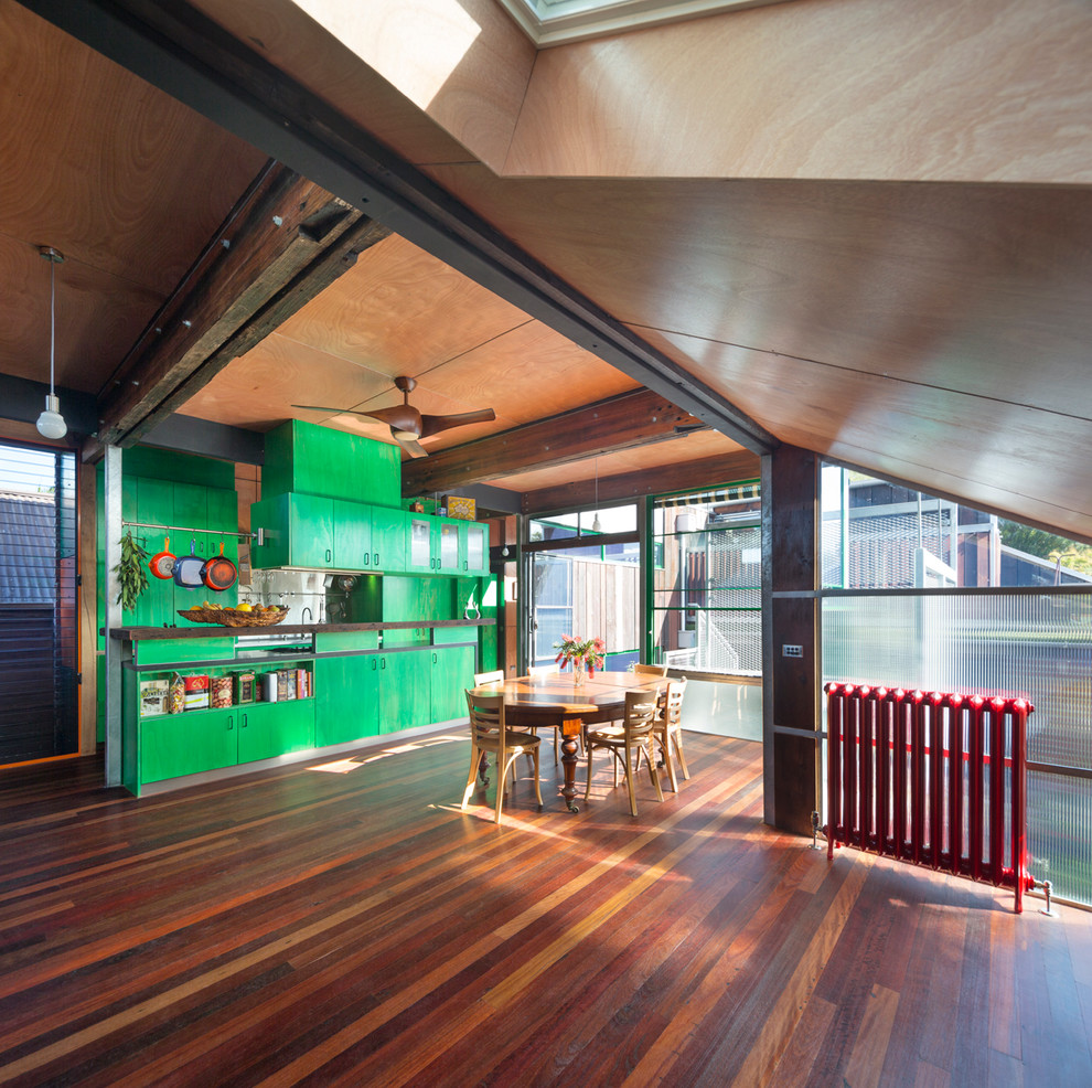 Example of an urban galley open concept kitchen design in Melbourne with flat-panel cabinets, green cabinets, metallic backsplash and metal backsplash