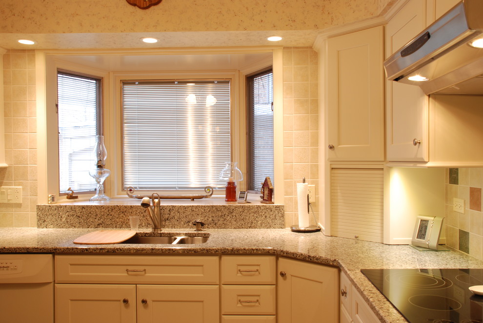 Photo of a medium sized bohemian l-shaped kitchen/diner in Chicago with a submerged sink, flat-panel cabinets, white cabinets, granite worktops, ceramic splashback and no island.