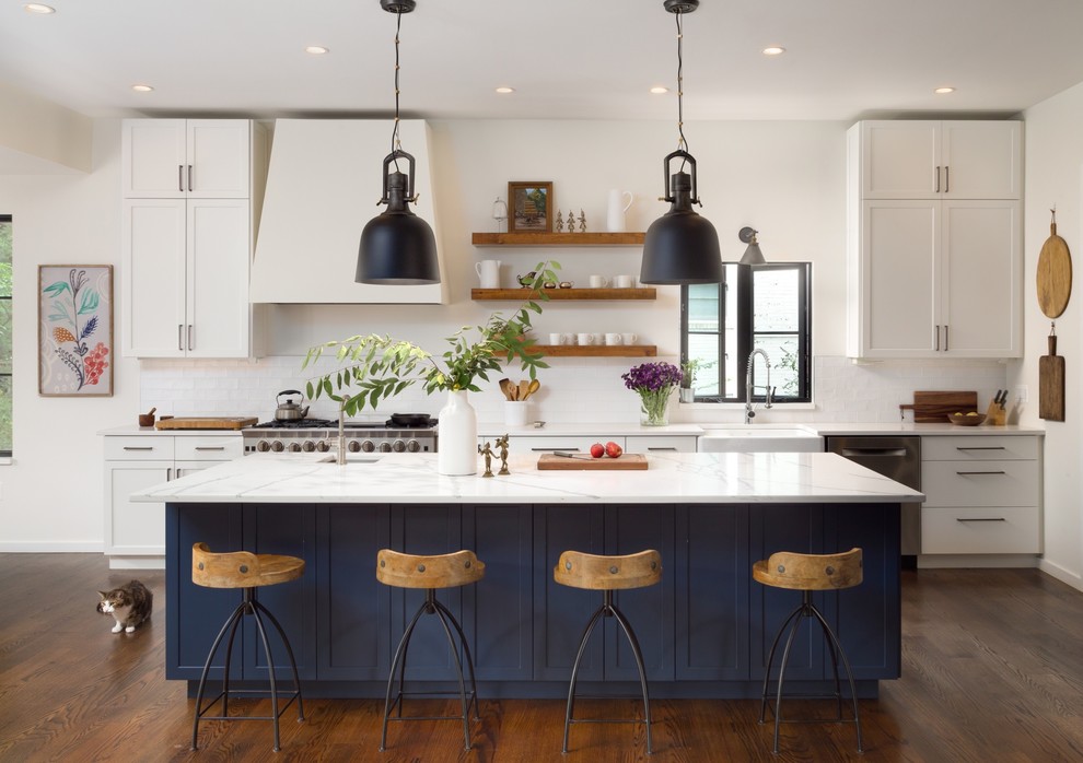 Inspiration for a transitional galley dark wood floor and brown floor kitchen remodel in DC Metro with a farmhouse sink, shaker cabinets, white cabinets, white backsplash, stainless steel appliances and an island
