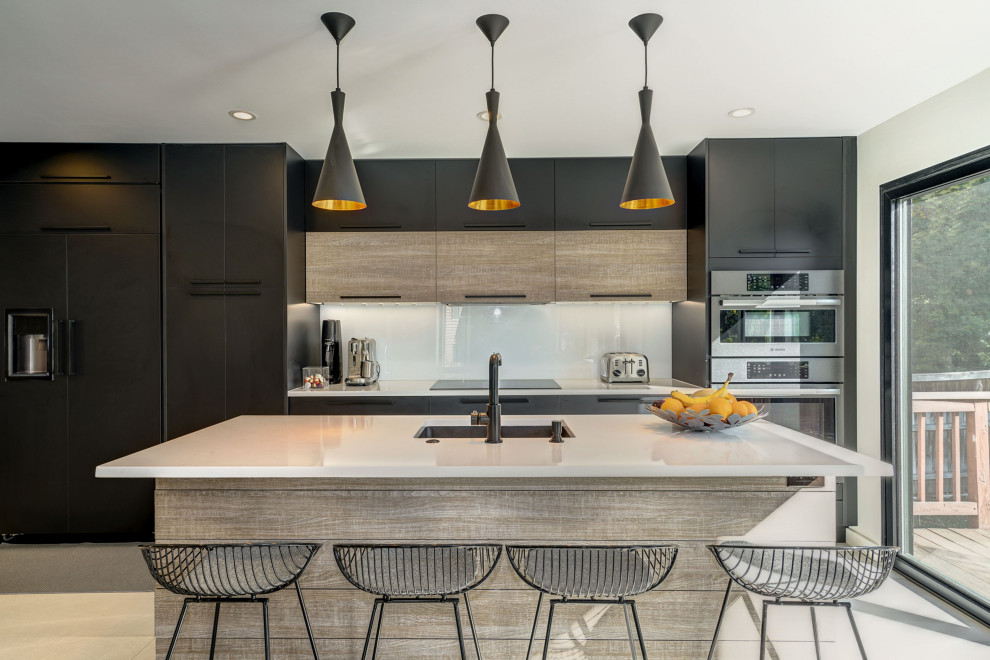 This is an example of a medium sized contemporary u-shaped kitchen/diner in DC Metro with flat-panel cabinets, black cabinets, quartz worktops, white splashback, porcelain flooring, an island, beige floors, white worktops, a submerged sink, integrated appliances and stone slab splashback.