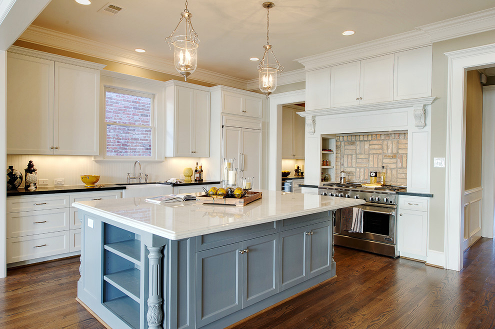 Classic kitchen in Houston with a belfast sink, recessed-panel cabinets, white cabinets and stainless steel appliances.