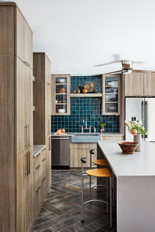 Esempio di un cucina con isola centrale industriale di medie dimensioni con ante marroni, paraspruzzi blu, elettrodomestici in acciaio inossidabile e top grigio