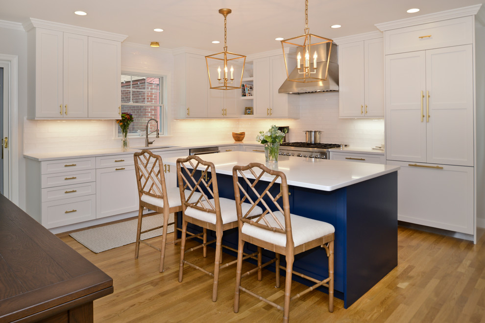 Inspiration for a mid-sized transitional l-shaped medium tone wood floor and brown floor eat-in kitchen remodel in DC Metro with shaker cabinets, quartz countertops, white backsplash, subway tile backsplash, paneled appliances, an island, white countertops, an undermount sink and white cabinets