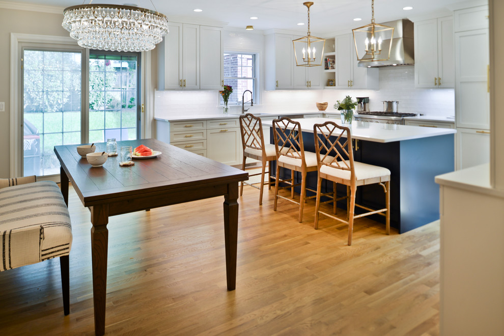 Inspiration for a mid-sized transitional l-shaped eat-in kitchen remodel in DC Metro with shaker cabinets, blue cabinets, quartz countertops, white backsplash, an island and white countertops