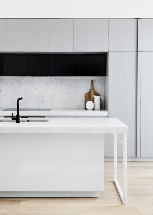 Monochromatic Magic: White Kitchen Island Concepts with Marble Slab Backsplash and Black Accents