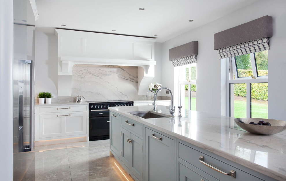 This is an example of a medium sized classic l-shaped open plan kitchen in Other with an integrated sink, shaker cabinets, blue cabinets, marble worktops, grey splashback, marble splashback, stainless steel appliances, porcelain flooring, an island and grey floors.