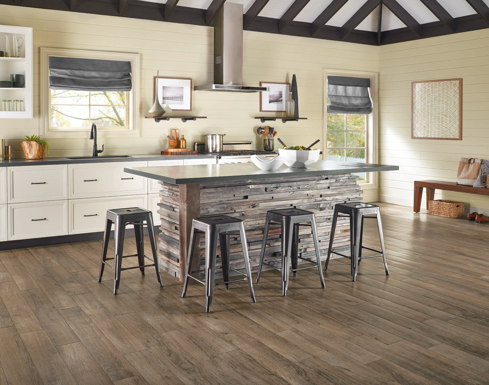 Kitchen - mid-sized rustic medium tone wood floor and brown floor kitchen idea in Other with an undermount sink, raised-panel cabinets, white cabinets, zinc countertops, beige backsplash, wood backsplash, stainless steel appliances and an island