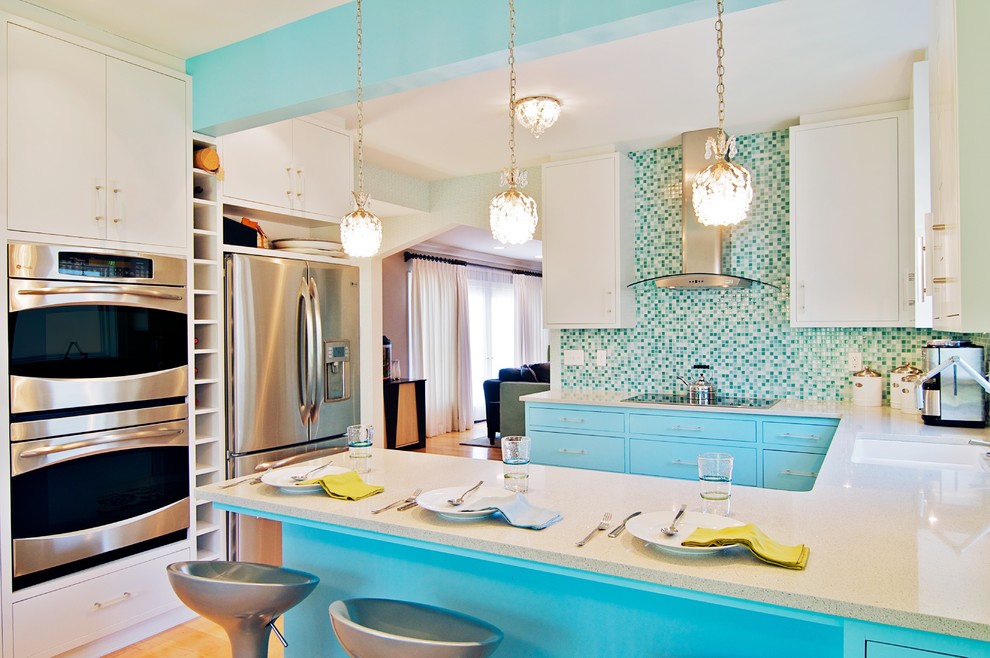 Example of a trendy u-shaped kitchen design in Chicago with stainless steel appliances, an undermount sink, flat-panel cabinets, white cabinets, mosaic tile backsplash and multicolored backsplash