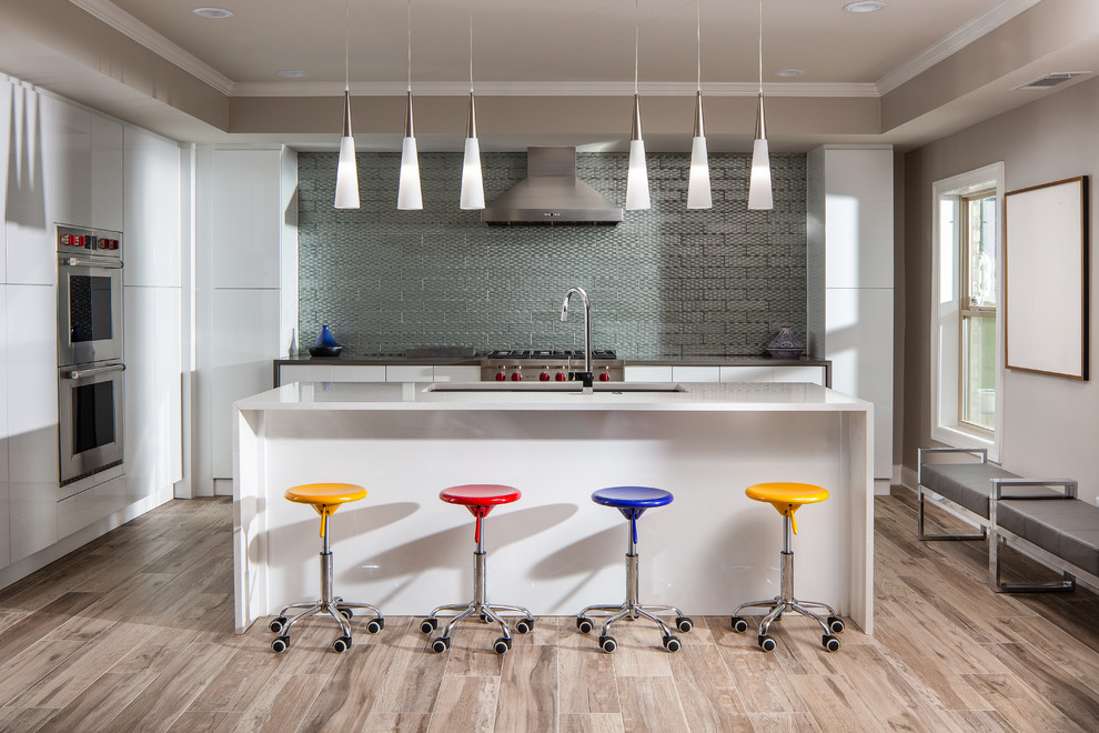 Inspiration for a mid-sized contemporary l-shaped porcelain tile and brown floor kitchen remodel in Atlanta with an undermount sink, flat-panel cabinets, white cabinets, metallic backsplash, metal backsplash, stainless steel appliances, an island, white countertops and quartzite countertops