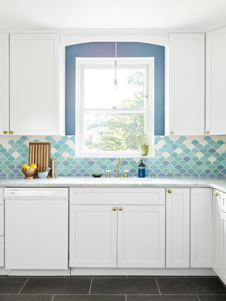 Inspiration for a mid-sized eclectic l-shaped porcelain tile eat-in kitchen remodel in Philadelphia with an undermount sink, shaker cabinets, white cabinets, marble countertops, blue backsplash, ceramic backsplash, white appliances and no island