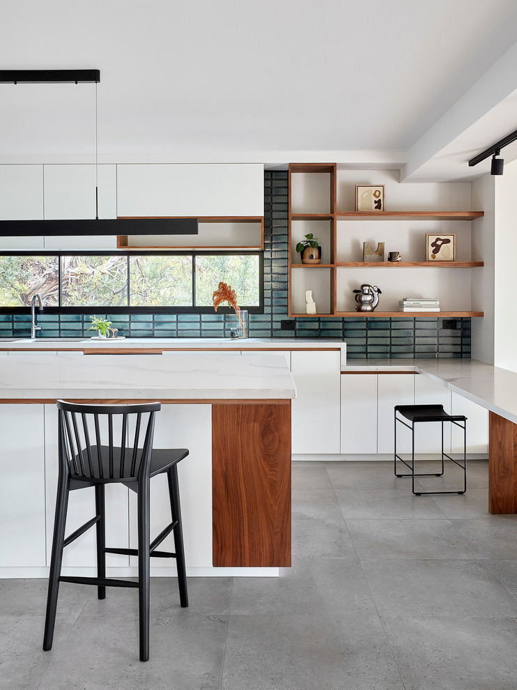 Design ideas for a large contemporary grey and white galley kitchen/diner in Melbourne with open cabinets, white cabinets, engineered stone countertops, mosaic tiled splashback, porcelain flooring, an island, grey floors, blue splashback, white worktops, an integrated sink, stainless steel appliances and exposed beams.