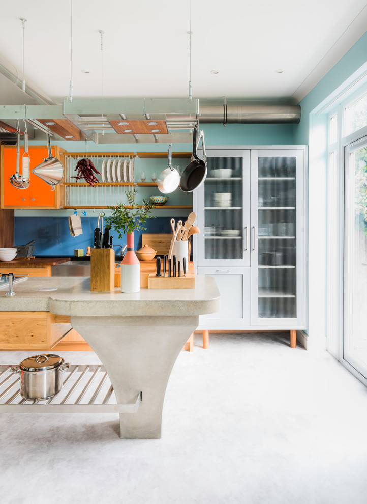 Foto de cocina ecléctica con armarios con paneles empotrados, puertas de armario naranjas, salpicadero azul, salpicadero de vidrio templado, una isla, suelo blanco y encimeras beige