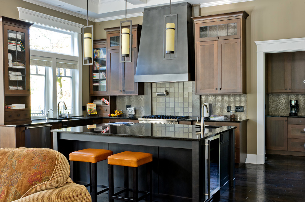 Eat-in kitchen - large contemporary l-shaped dark wood floor eat-in kitchen idea in Vancouver with a drop-in sink, beaded inset cabinets, granite countertops, multicolored backsplash, mosaic tile backsplash, stainless steel appliances, an island and medium tone wood cabinets