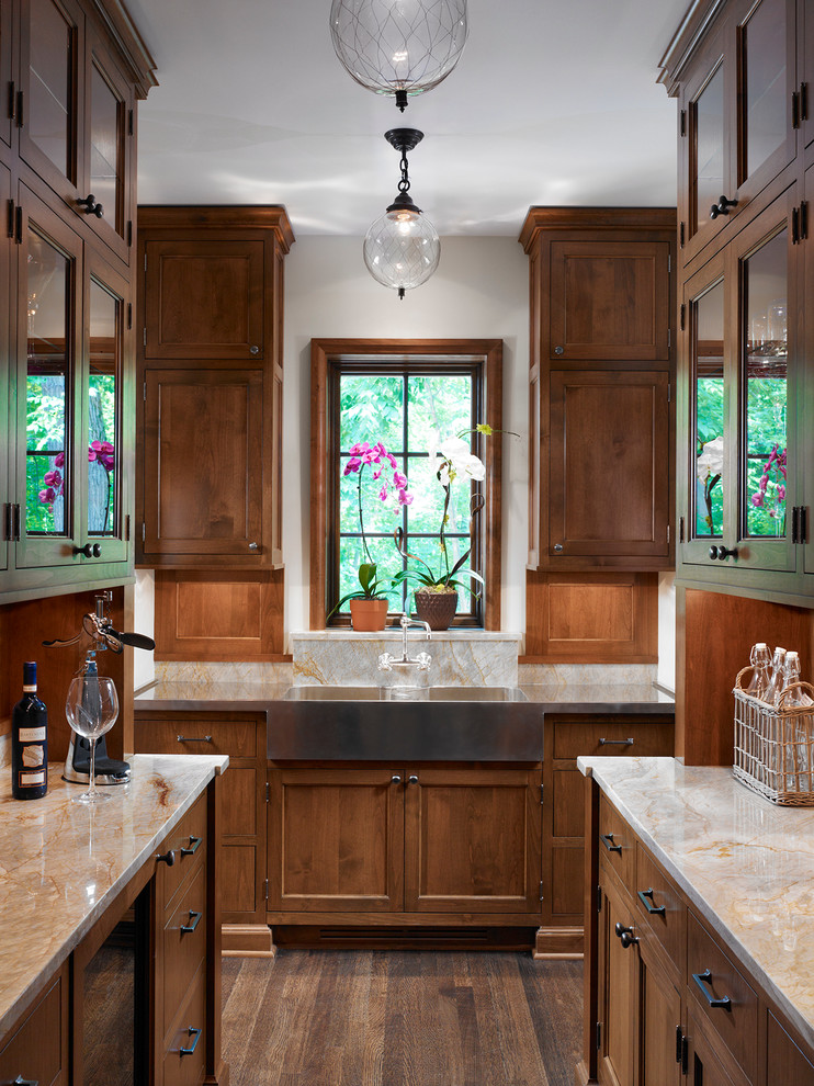 Example of a mid-sized classic galley medium tone wood floor kitchen pantry design in Chicago with a farmhouse sink, shaker cabinets, medium tone wood cabinets, quartzite countertops and no island