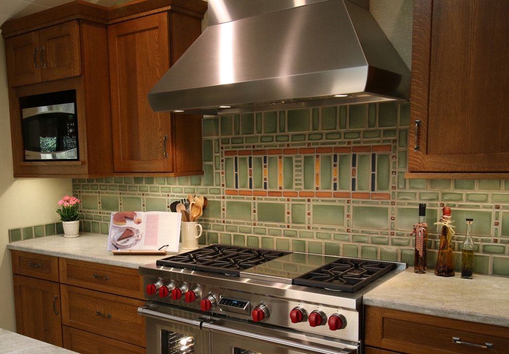 Exempel på ett stort amerikanskt vit vitt kök, med en undermonterad diskho, skåp i shakerstil, skåp i mellenmörkt trä, bänkskiva i kvarts, grönt stänkskydd, stänkskydd i keramik, rostfria vitvaror, klinkergolv i porslin, en köksö och beiget golv