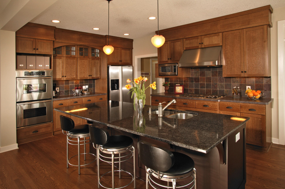 Classic kitchen in Minneapolis with stainless steel appliances and slate splashback.