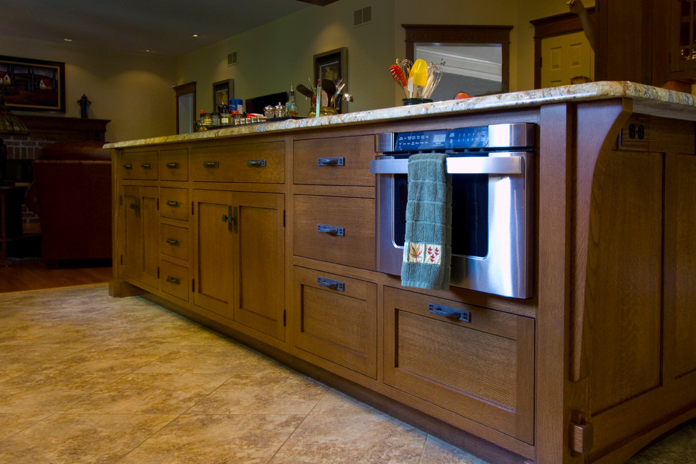 Example of a large classic u-shaped travertine floor eat-in kitchen design in Other with medium tone wood cabinets, granite countertops, stainless steel appliances, an island, flat-panel cabinets, a double-bowl sink, white backsplash and subway tile backsplash