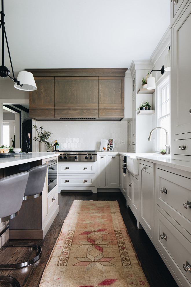 Inspiration for a mid-sized timeless open concept kitchen remodel in Chicago with shaker cabinets, white cabinets, quartz countertops, white backsplash, ceramic backsplash, stainless steel appliances, an island and white countertops