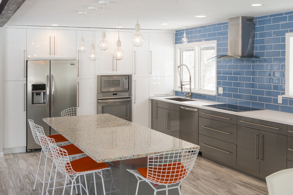 Inspiration for a mid-sized modern l-shaped ceramic tile eat-in kitchen remodel in Other with a single-bowl sink, recycled glass countertops, blue backsplash, glass tile backsplash, stainless steel appliances and an island