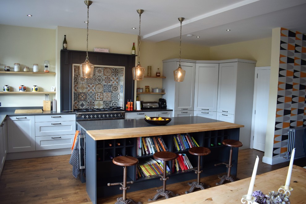 Photo of a classic kitchen in Other with shaker cabinets and an island.