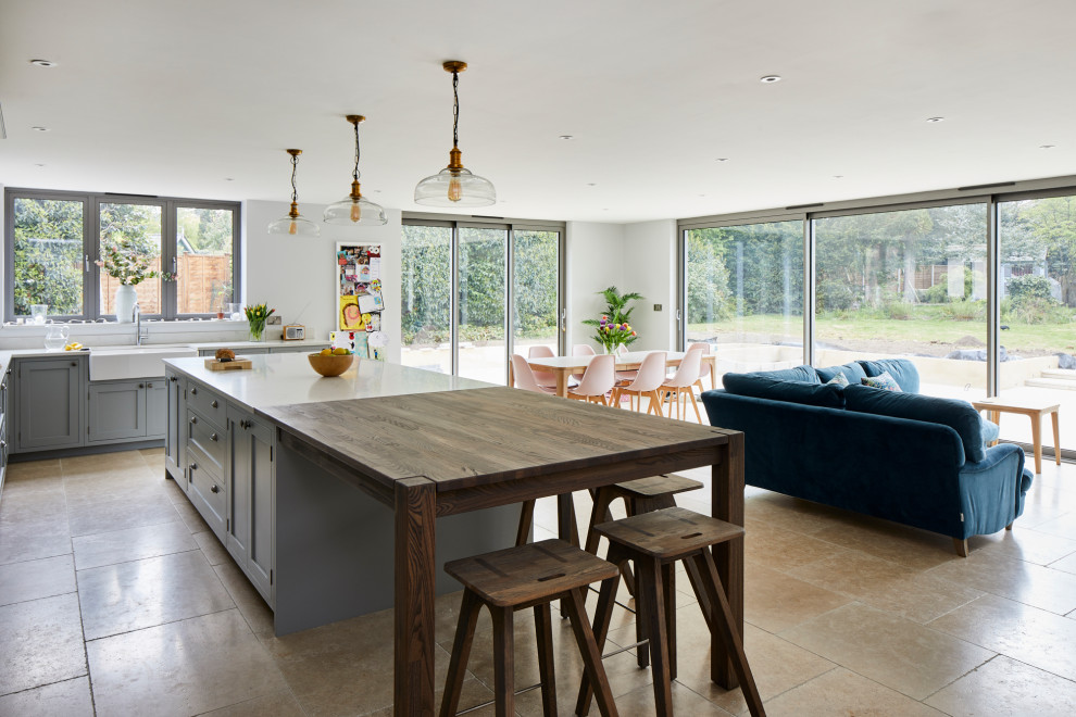 Design ideas for a large classic l-shaped open plan kitchen in Kent with a belfast sink, quartz worktops and an island.