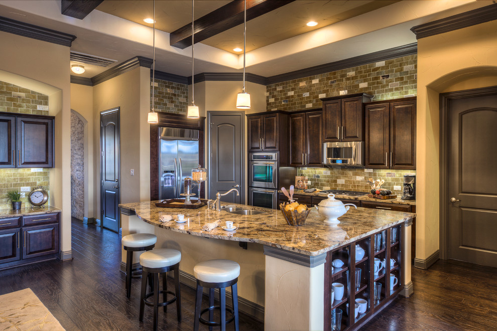 Open concept kitchen - large traditional single-wall dark wood floor open concept kitchen idea in Austin with an undermount sink, raised-panel cabinets, dark wood cabinets, granite countertops, multicolored backsplash, ceramic backsplash, stainless steel appliances and an island