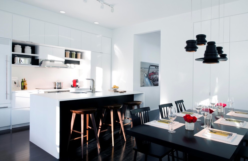 Inspiration for a small contemporary single-wall kitchen/diner in Orlando with a submerged sink, flat-panel cabinets, white cabinets, composite countertops, white splashback, stainless steel appliances, dark hardwood flooring and an island.
