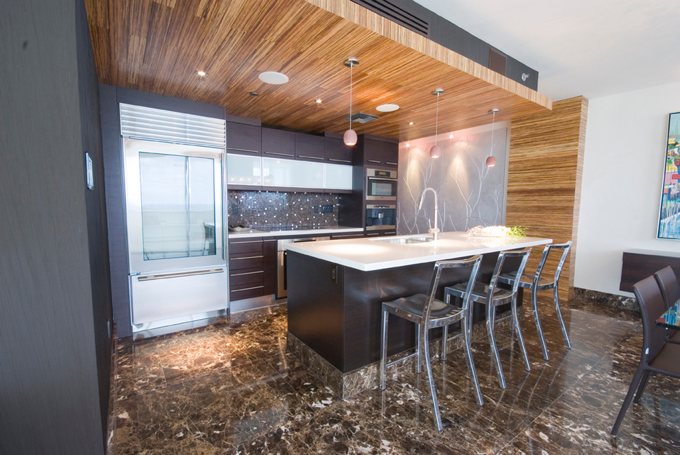 This is an example of a contemporary galley open plan kitchen in Miami with flat-panel cabinets, brown cabinets, brown splashback, stainless steel appliances, a submerged sink, quartz worktops and mosaic tiled splashback.