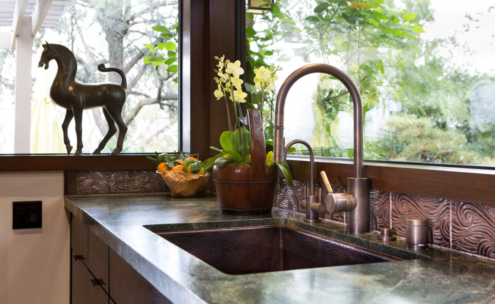 Inspiration for a medium sized world-inspired l-shaped kitchen in Los Angeles with a submerged sink, flat-panel cabinets, medium wood cabinets, quartz worktops, brown splashback, ceramic splashback, integrated appliances, medium hardwood flooring and an island.