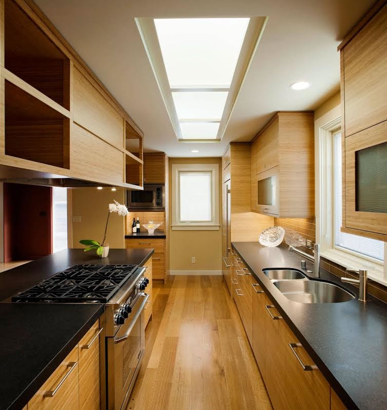 Enclosed kitchen - mid-sized contemporary galley medium tone wood floor enclosed kitchen idea in San Francisco with stainless steel appliances, an undermount sink, flat-panel cabinets, medium tone wood cabinets and brown backsplash