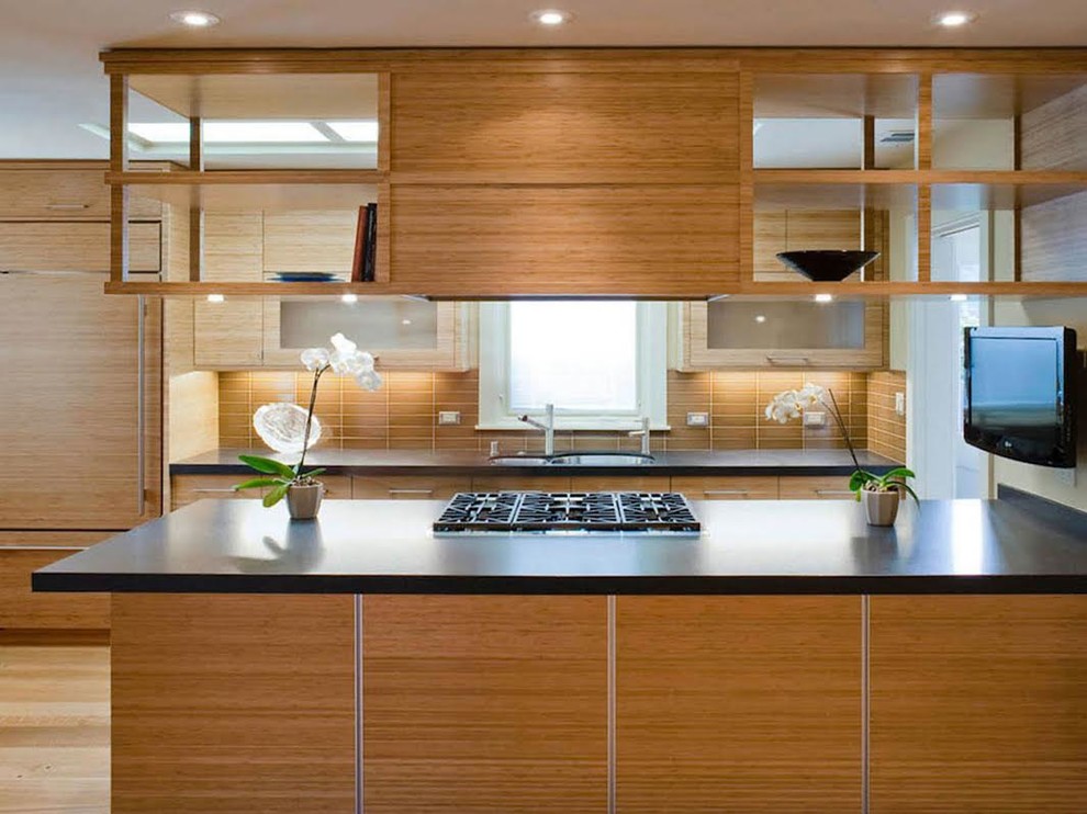 Example of a mid-sized trendy galley medium tone wood floor enclosed kitchen design in San Francisco with brown backsplash, granite countertops, an undermount sink, flat-panel cabinets, medium tone wood cabinets and stainless steel appliances